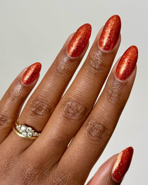 taylor swift tloas orange nails with glitter